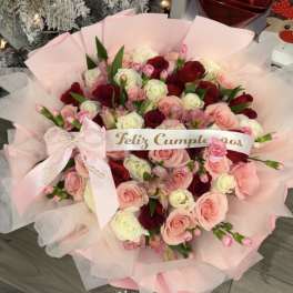 Pink and red rose bouquet with a birthday ribbon and bow