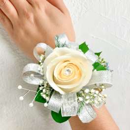 Cream rose wrist corsage with silver ribbon and baby's breath
