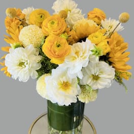 Yellow and white bouquet in a glass vase