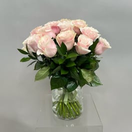 Bouquet of pale pink roses in a clear glass vase