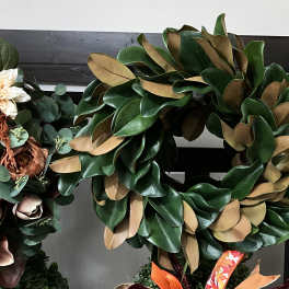 Large green and tan wreath made of magnolia leaves