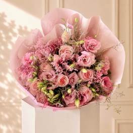 Pink rose bouquet wrapped in pale pink paper