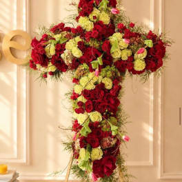 Large cross-shaped floral arrangement of red and pale yellow roses