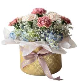 Pink and white carnations with blue hydrangeas in a gold hatbox