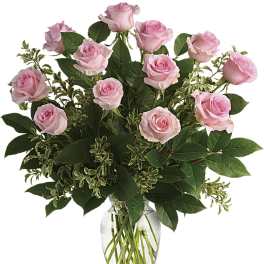 Arrangement of light pink roses in a clear glass vase