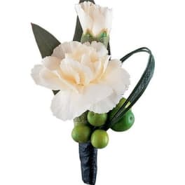 White carnation boutonniere with green berries and dark leaves