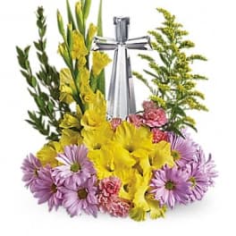 Yellow and purple floral spray with a silver ribbon centerpiece