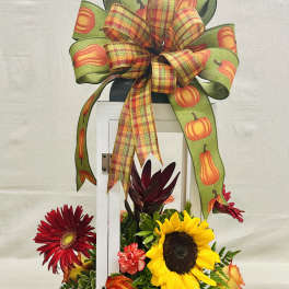 Fall floral arrangement with sunflowers, roses, and a pumpkin ribbon bow