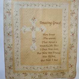 Quilted wall hanging with floral border and the words Amazing Grace