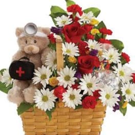 Basket of red roses and white daisies with a teddy bear holding a black heart