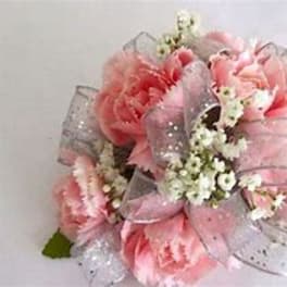 Pink floral bouquet with sheer ribbon and small white filler flowers