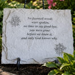 Memorial stone plaque with a sympathy verse in a garden setting
