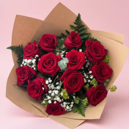 Bouquet of red roses wrapped in brown paper