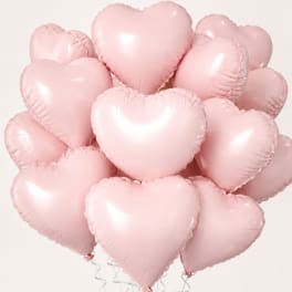 Cluster of pale pink heart-shaped balloons on a light background