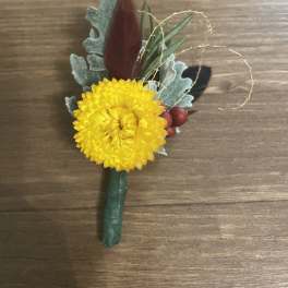 Yellow chrysanthemum boutonniere with berries and foliage