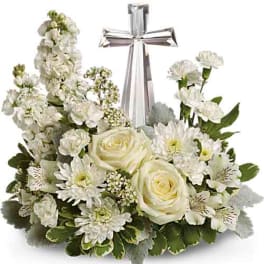 White floral arrangement with a silver cross centerpiece