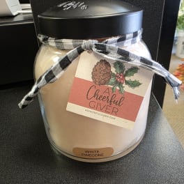White pinecone candle jar with a black lid and plaid ribbon