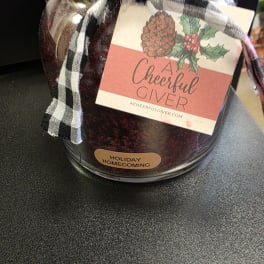 Holiday gift jar with plaid ribbon and a Cheerful Giver label