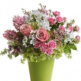 Pink roses and white flowers in a green vase