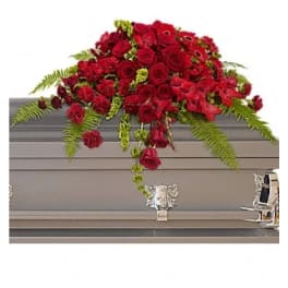 Red rose casket spray with fern accents