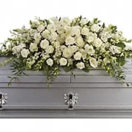 White floral spray on a silver casket
