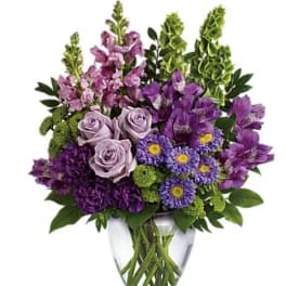 Purple and lavender bouquet in a clear glass vase