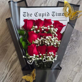 Bouquet of red roses with baby's breath in black wrap