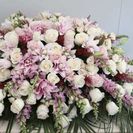Large pink and white floral arrangement with roses and lilies