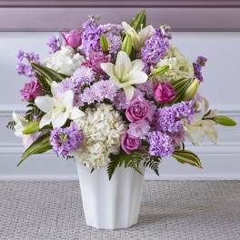 Pink and white floral arrangement in a white vase