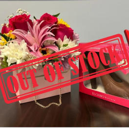 Flower box with roses and daisies beside a shoe box