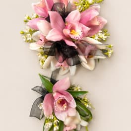 Pink and white orchid corsages with black ribbon accents