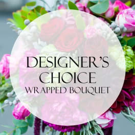 Wrapped bouquet of pink and white flowers with greenery