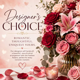 Pink and red rose bouquet with a lily in a glass vase