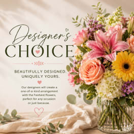 Mixed bouquet in a clear glass vase with pink lily, rose, gerbera, and hydrangea blooms