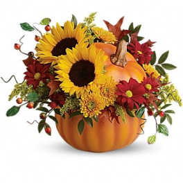 Pumpkin-shaped arrangement with sunflowers and red fall flowers