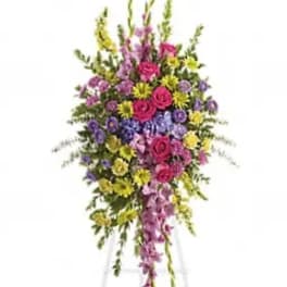 Tall standing floral spray with pink, purple, and yellow flowers