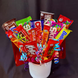 Candy bouquet in a white container with colorful ribbon curls