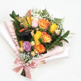 Bouquet of multicolored roses with a graduation cap and chocolates