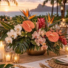Tropical centerpiece with orchids, anthuriums, and bird of paradise in a low bowl