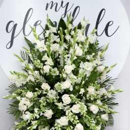 Large white floral standing spray on an easel