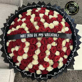 Round bouquet of red and white roses with a Valentine ribbon