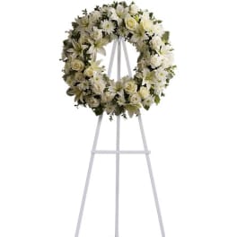 White floral wreath on a standing easel