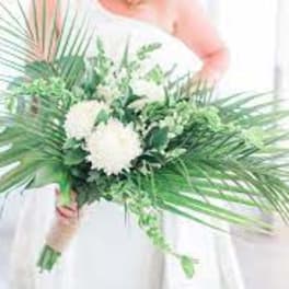 White floral bouquet with palm fronds and greenery