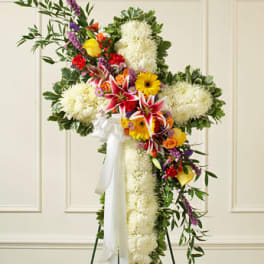 Standing floral cross with white flowers and colorful mixed blooms