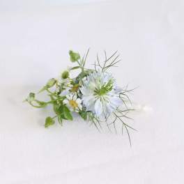 Small white flower arrangement with airy greenery on a white background