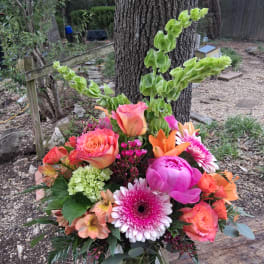 Bright mixed bouquet with roses, gerbera daisies, and lilies in a vase