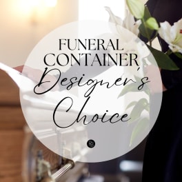 White funeral flowers with green buds beside a casket