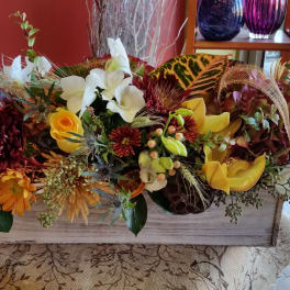 Large autumn floral arrangement in a rectangular wooden box with yellow and white blooms