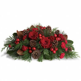 Low red rose and evergreen centerpiece with pine cones and red berries