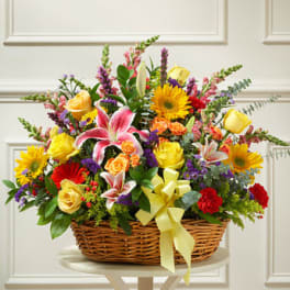 Large mixed flower basket with lilies, roses, gerbera daisies and a yellow bow